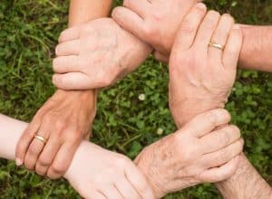 PEOPLE HOLDING HANDS FOR CONNECTION