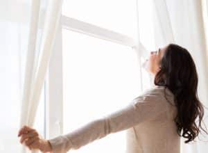 Girl looking out window feeling happy