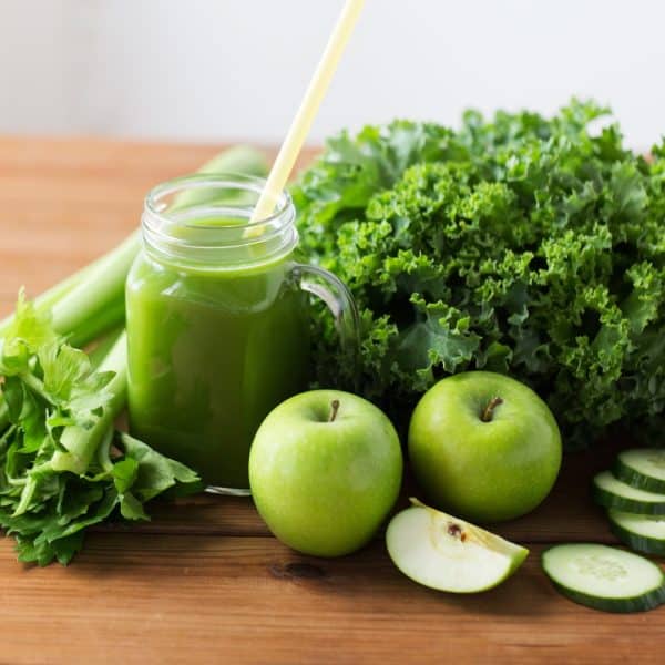 JUICING WITHOUT A JUICER: GREEN JUICEI WITH APPLES AND GREENS ON A TABLE